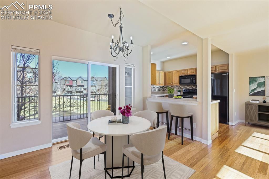 4058 Star View Colorado Springs, CO 80907 - Photo 14 of 43 a view of a dining room with furniture window and wooden floor