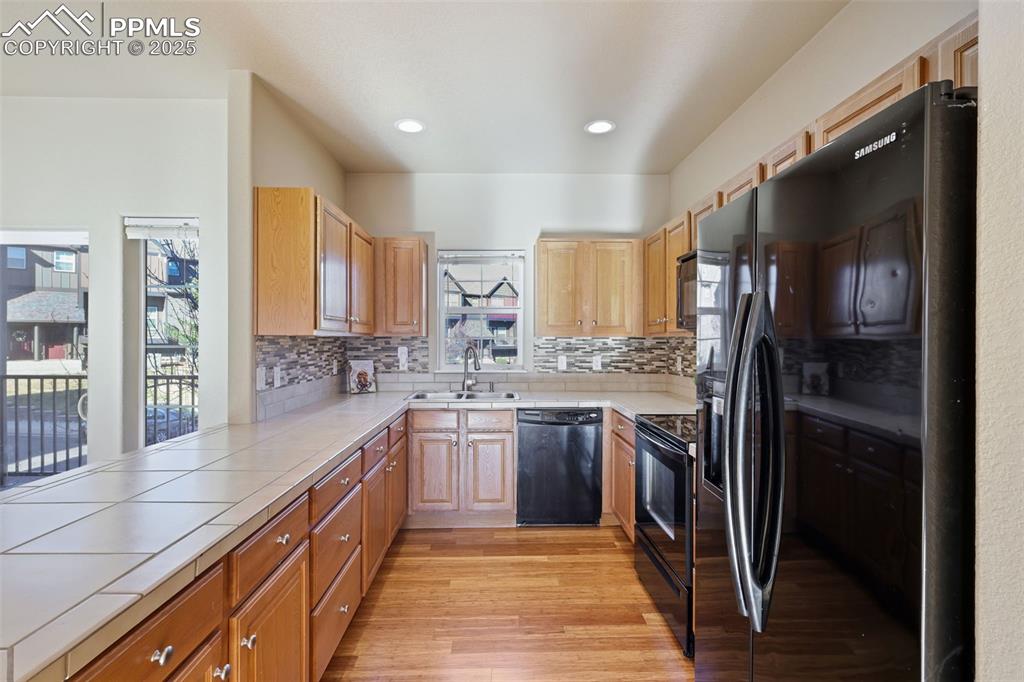 4058 Star View Colorado Springs, CO 80907 - Photo 17 of 43 a large kitchen with stainless steel appliances granite countertop a refrigerator and a sink