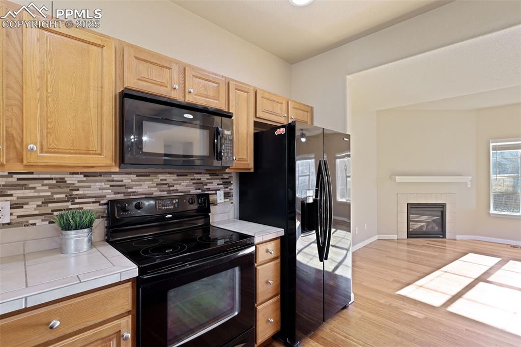 4058 Star View Colorado Springs, CO 80907 - Photo 18 of 43 a kitchen with granite countertop a stove and a microwave