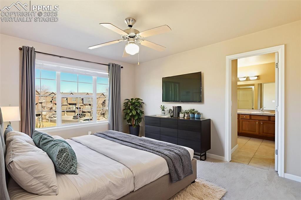 4058 Star View Colorado Springs, CO 80907 - Photo 23 of 43 a bedroom with a bed and a flat screen tv