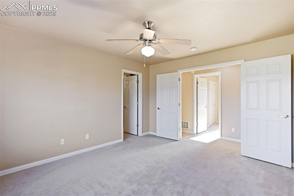 4058 Star View Colorado Springs, CO 80907 - Photo 23 of 41 an empty room with closet and a chandelier fan