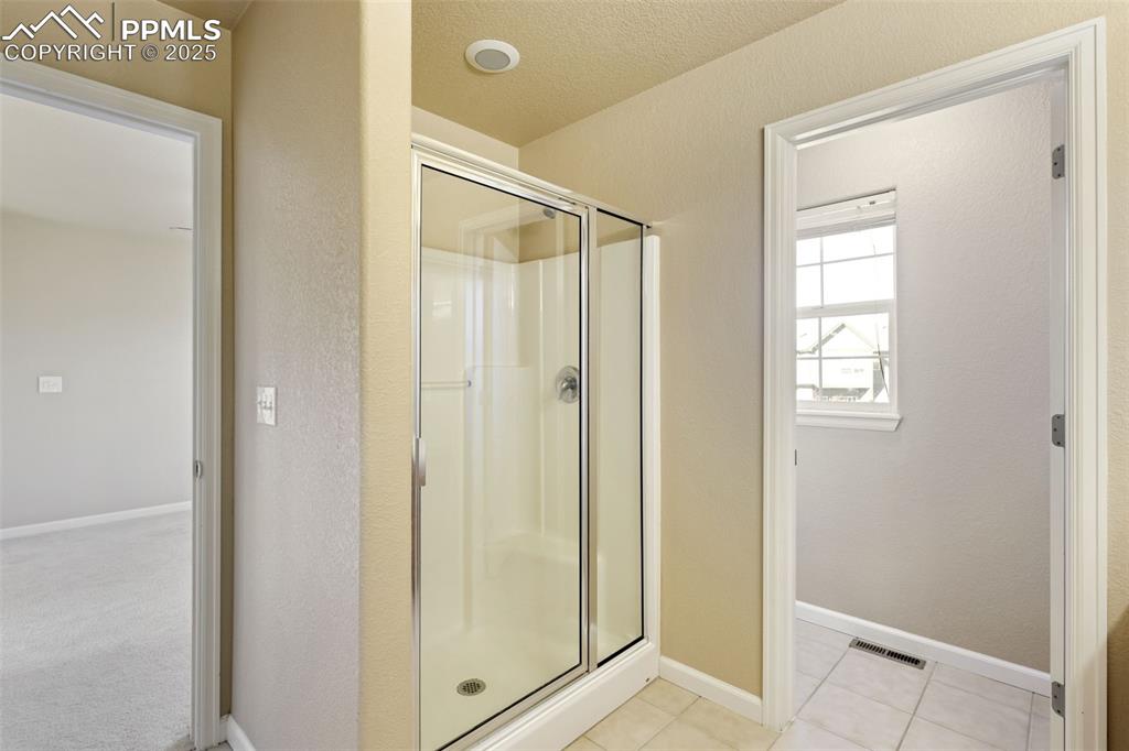 4058 Star View Colorado Springs, CO 80907 - Photo 28 of 43 a bathroom with a glass shower door