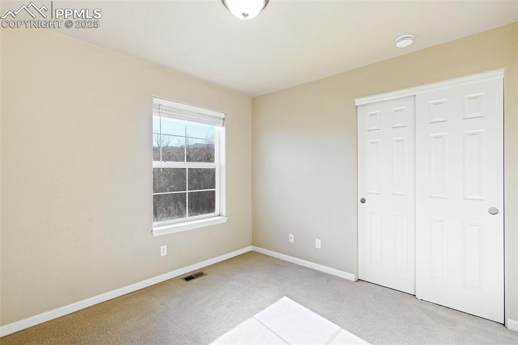 4058 Star View Colorado Springs, CO 80907 - Photo 32 of 43 an empty room with windows