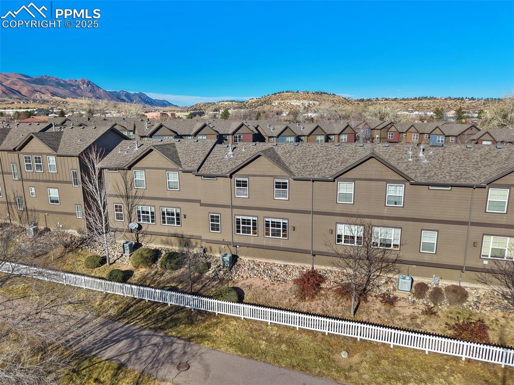 4058 Star View Colorado Springs, CO 80907 - Photo 37 of 43 a view of a white house with a large windows next to a road