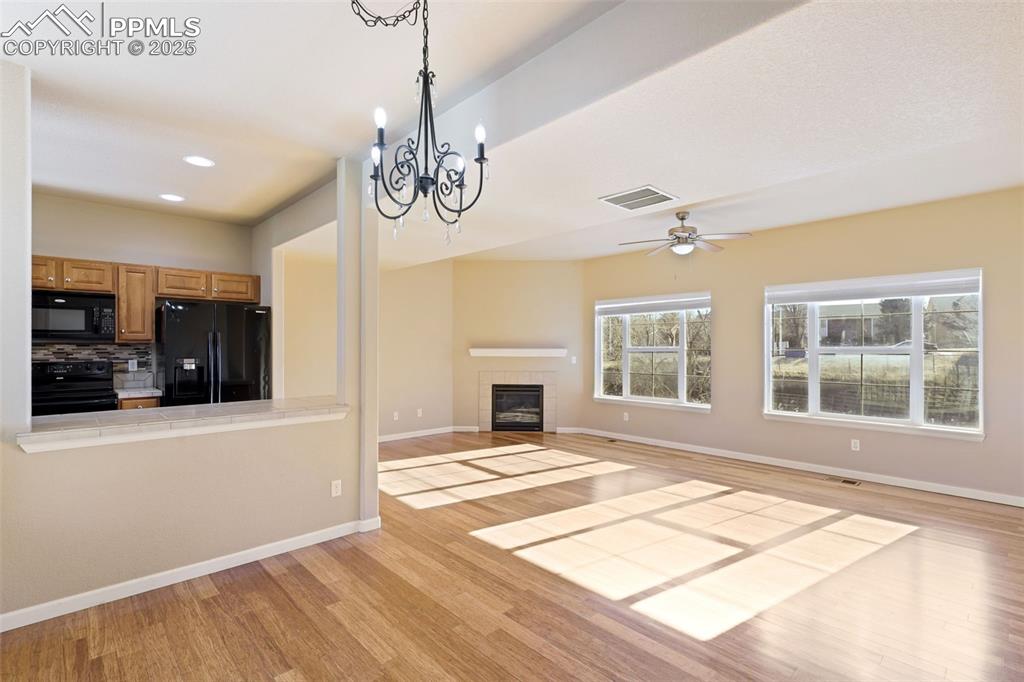 4058 Star View Colorado Springs, CO 80907 - Photo 8 of 41 a view of an empty room with a window and kitchen view