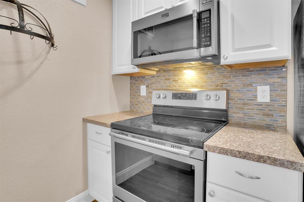 449 Harris Street, Unit I102 Coppell, TX 75019 - Photo 11 of 33 a stove top oven sitting inside of a kitchen