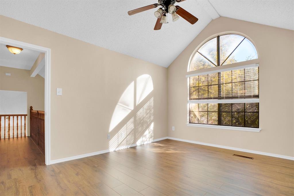 449 Harris Street, Unit I102 Coppell, TX 75019 - Photo 15 of 33 an empty room with wooden floor fan and windows
