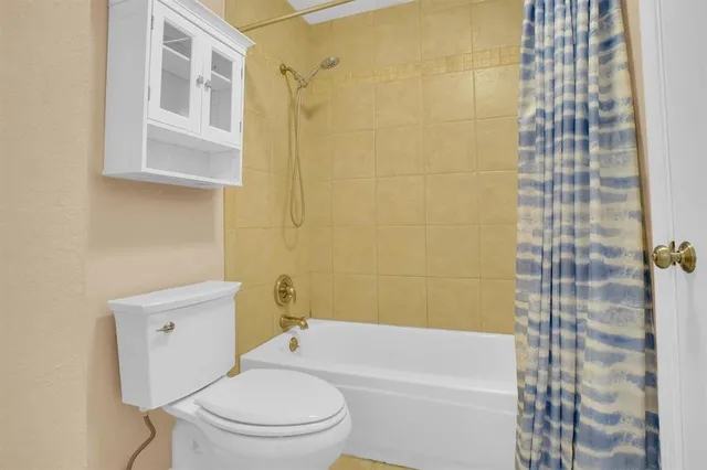 a bathroom with a granite countertop sink a mirror and a bathtub
