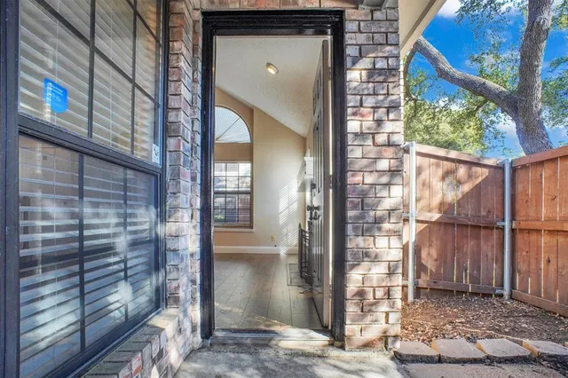 a brick building with a window and a door