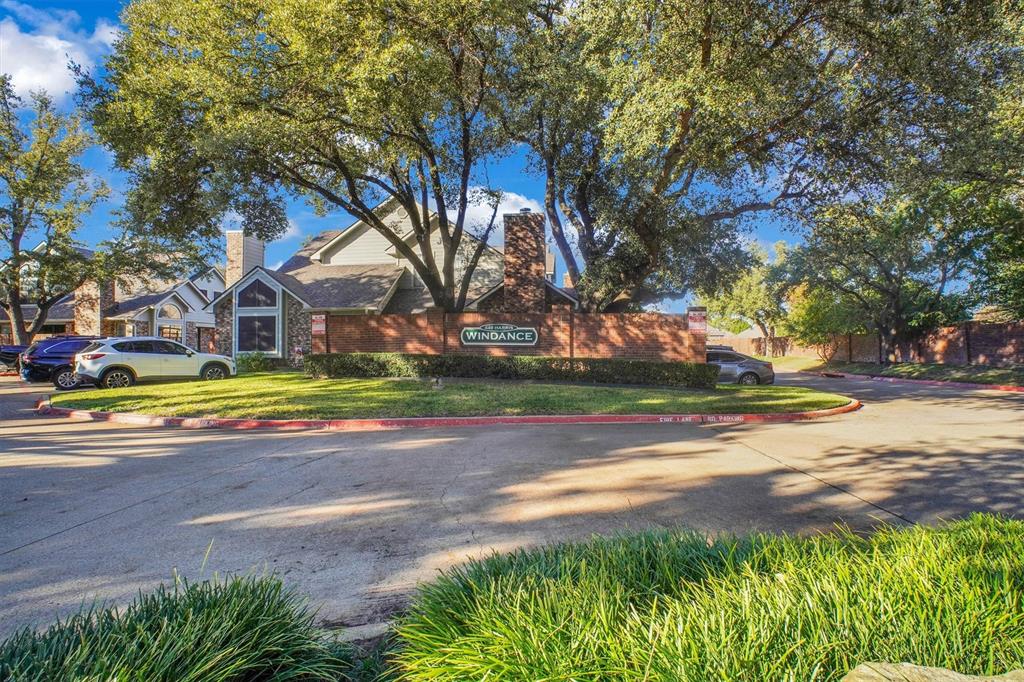 449 Harris Street, Unit I102 Coppell, TX 75019 - Photo 28 of 33 a view of the house with a big yard and large trees