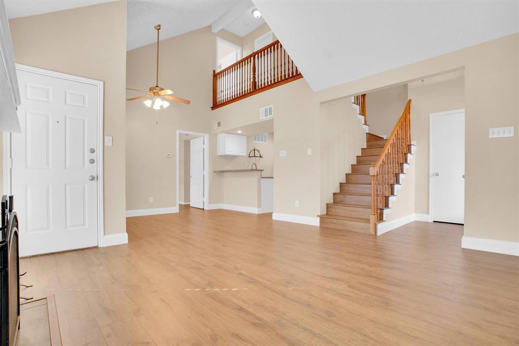 449 Harris Street, Unit I102 Coppell, TX 75019 - Photo 2 of 33 a view of an empty room with wooden floor and staircase