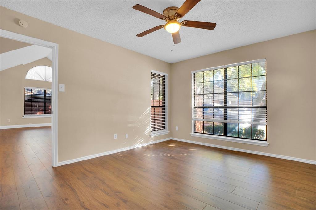449 Harris Street, Unit I102 Coppell, TX 75019 - Photo 5 of 33 a view of an empty room with wooden floor and a window