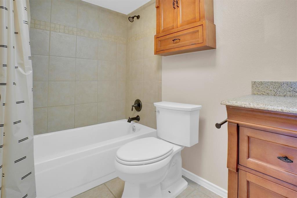 449 Harris Street, Unit I102 Coppell, TX 75019 - Photo 8 of 33 a bathroom with a toilet and a bathtub