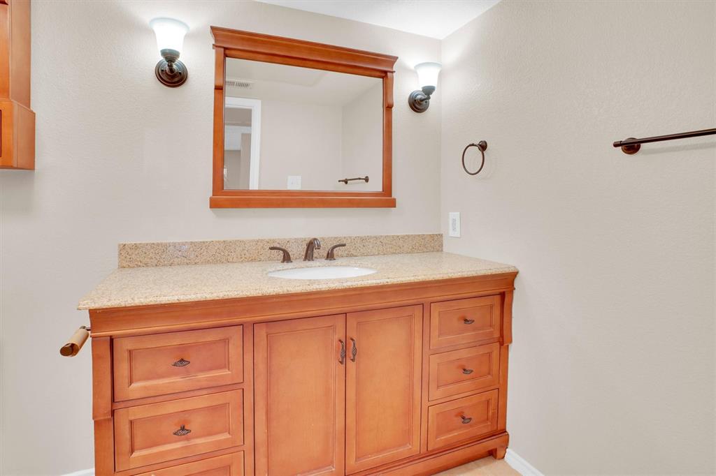 449 Harris Street, Unit I102 Coppell, TX 75019 - Photo 9 of 33 a bathroom with a sink vanity and a mirror