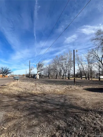 a view of a yard with wooden fence