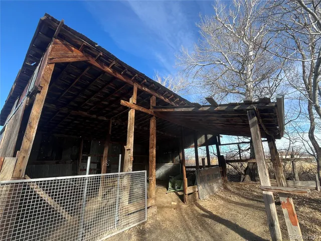 a view of a house with backyard porch and sitting area