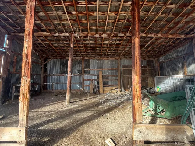 a view of a porch with a table and chairs
