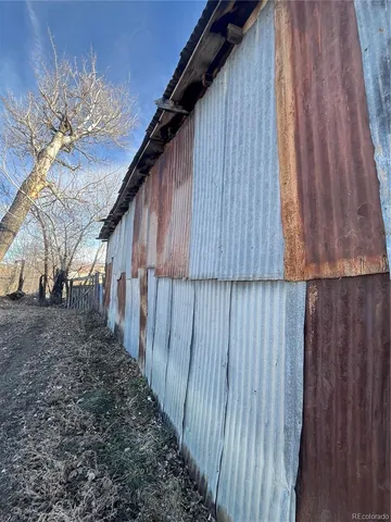 a view of a house with wooden fence