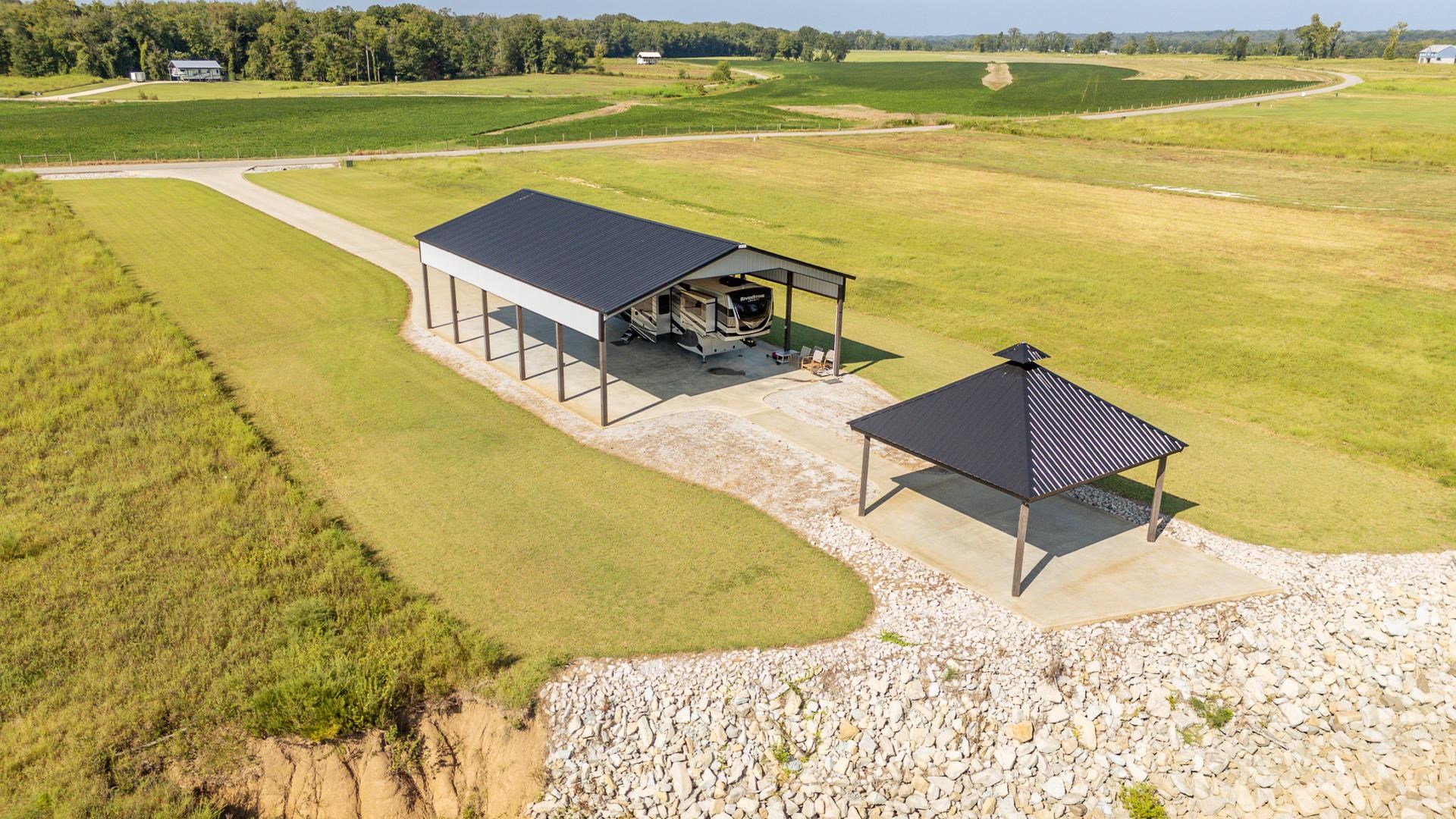 6235 Cravens Road Savannah, TN 38372 - Photo 3 of 11 View of home's community featuring a patio, a carport, an outdoor structure, a view of countryside, and a pole building