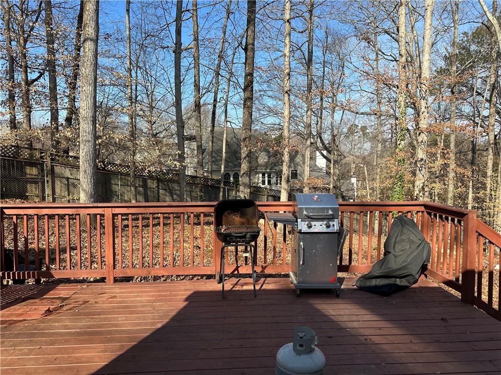 455 Rill Crest Court Alpharetta, GA 30022 - Photo 2 of 13 a view of a balcony with chairs and wooden floor