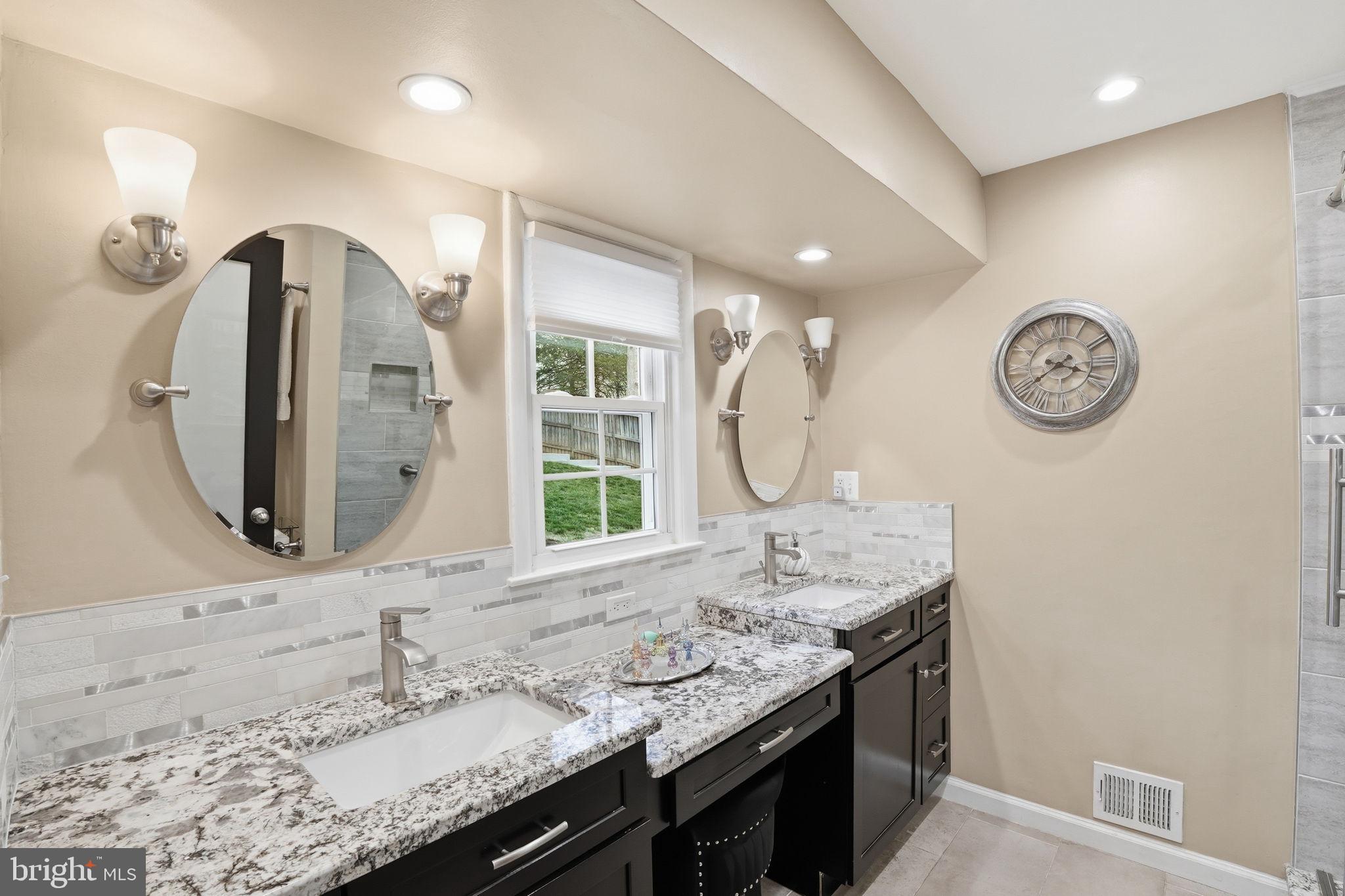 1821 Briggs Road Silver Spring, MD 20906 - Photo 13 of 23 a bathroom with a granite countertop sink and a mirror
