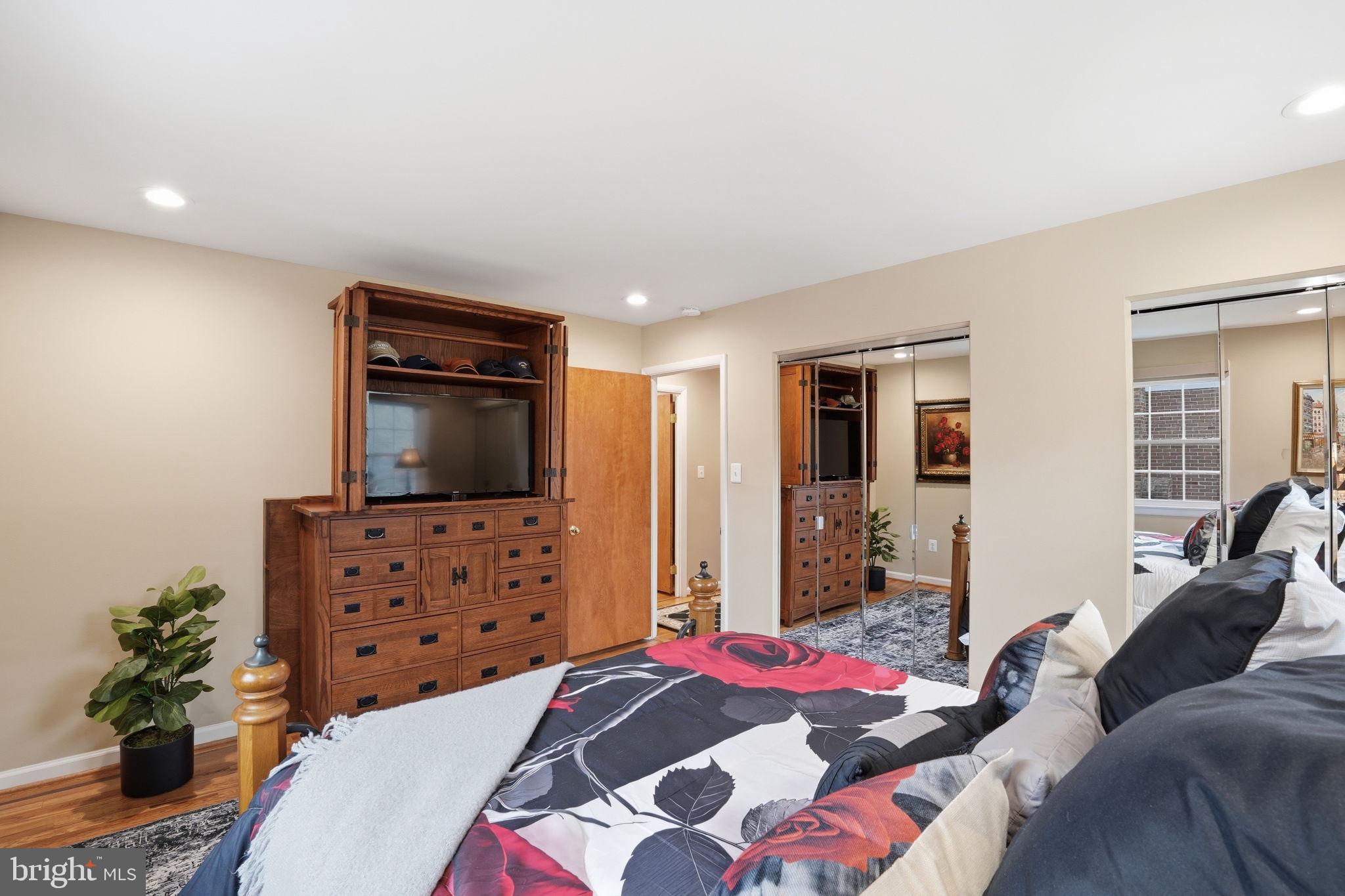 1821 Briggs Road Silver Spring, MD 20906 - Photo 16 of 23 a bedroom with a bed and flat screen tv