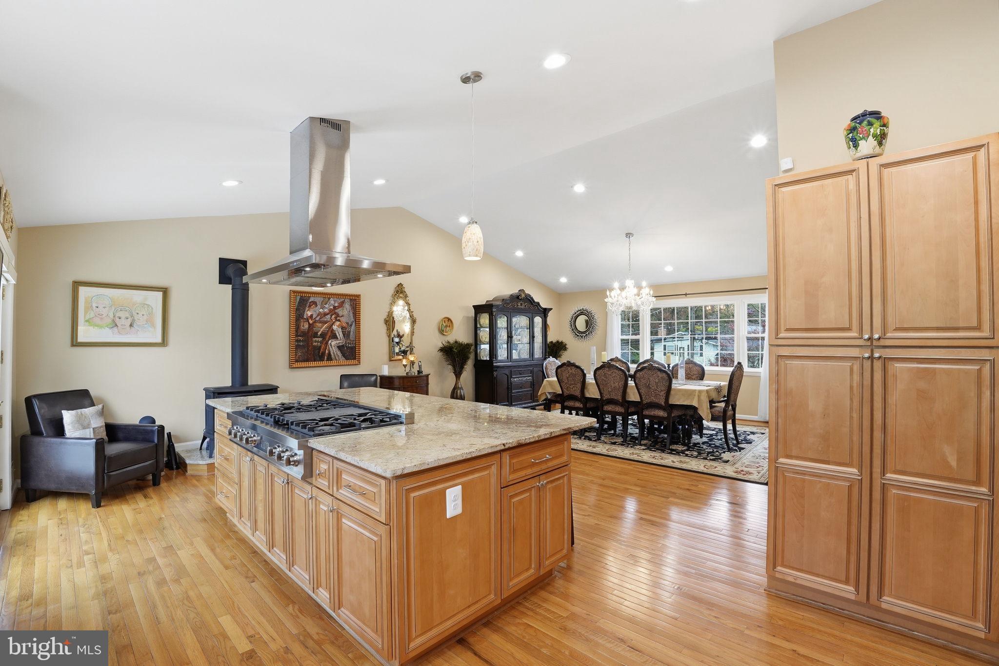 1821 Briggs Road Silver Spring, MD 20906 - Photo 2 of 23 a kitchen with stainless steel appliances granite countertop a refrigerator a stove and a wooden floors