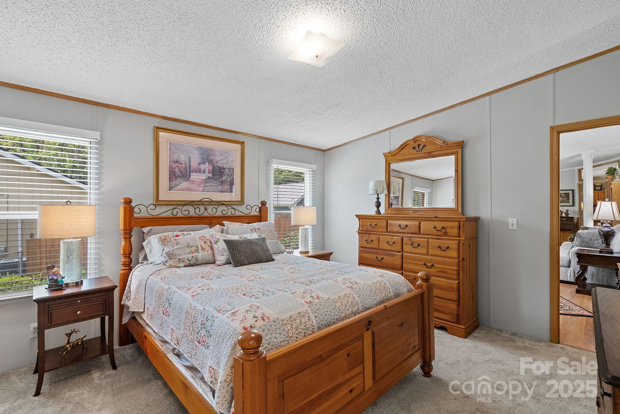 213 Old State 10 Road Black Mountain, NC 28711 - Photo 18 of 44 a bedroom with a bed and a chandelier