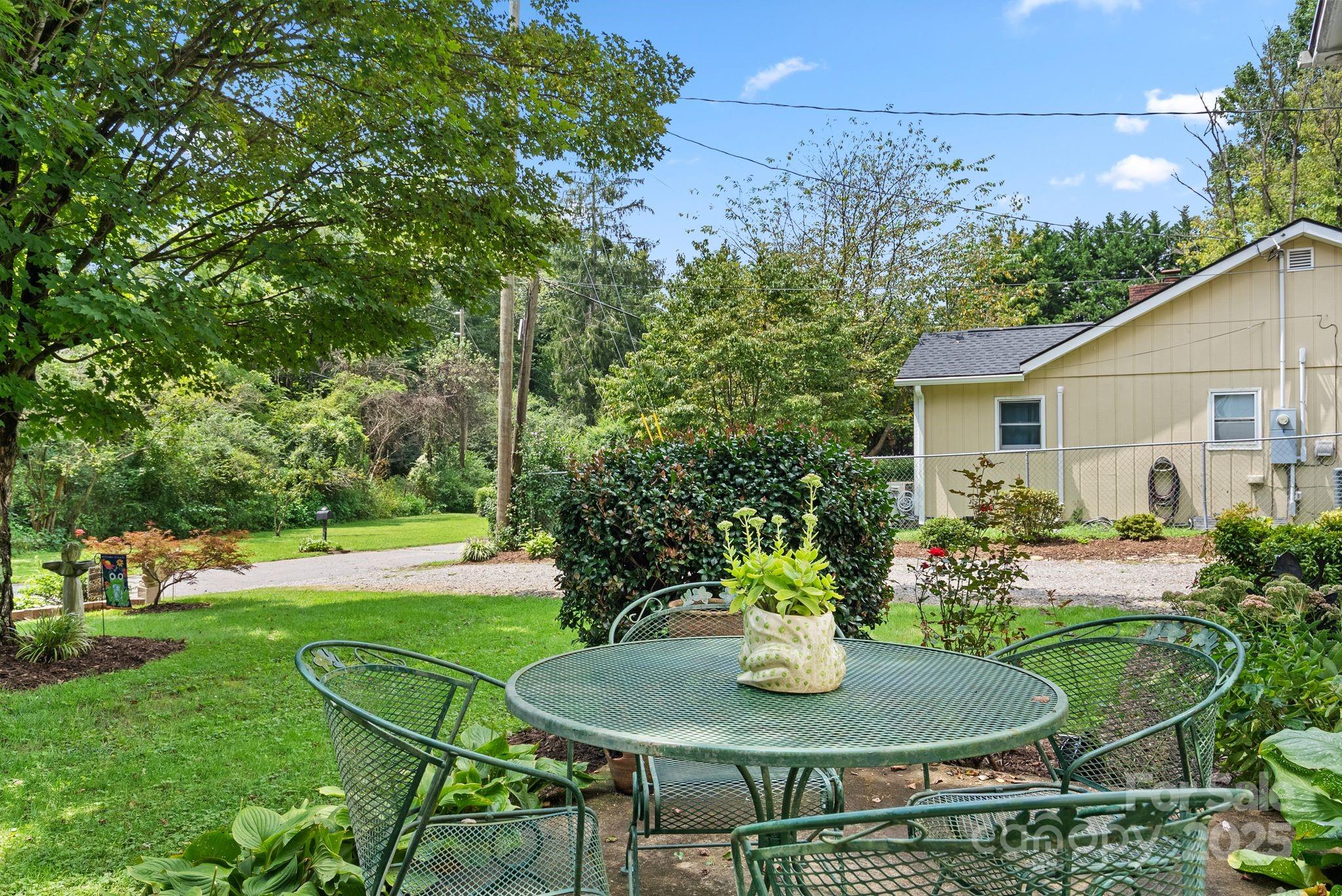 213 Old State 10 Road Black Mountain, NC 28711 - Photo 31 of 44 a backyard with table and chairs and potted plants