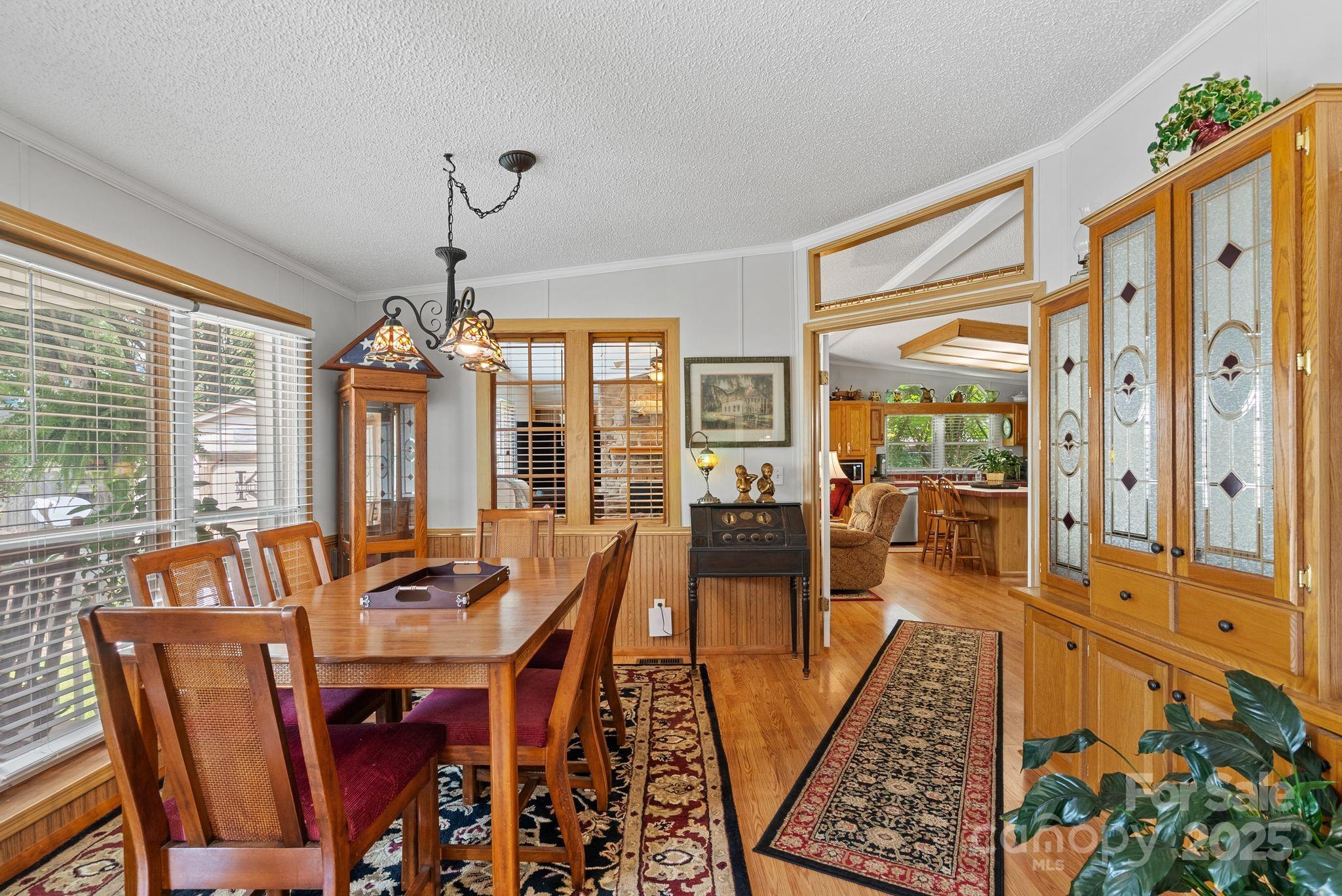 213 Old State 10 Road Black Mountain, NC 28711 - Photo 9 of 44 a dining room with furniture a chandelier and wooden floor