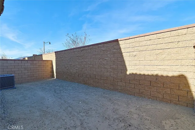 a living room with furniture a flat screen tv a rug and a window