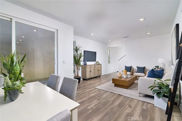 a view of a dining room with furniture and a kitchen