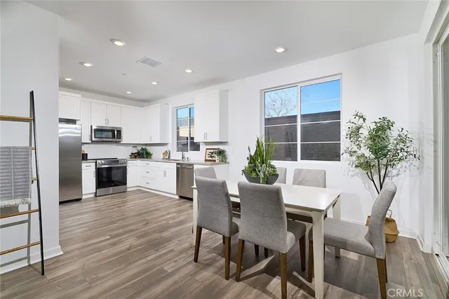 a kitchen with granite countertop cabinets stainless steel appliances a sink and a window