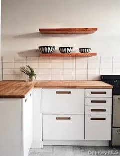 a kitchen with a refrigerator and a stove
