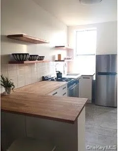 a kitchen with a refrigerator and a sink