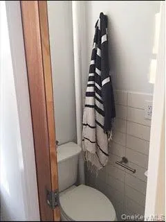 a white toilet sitting next to a shower and a sink