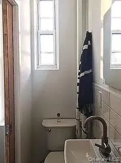 a bathroom with a toilet a sink and bathtub