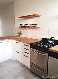 a kitchen with granite countertop a stove and a sink