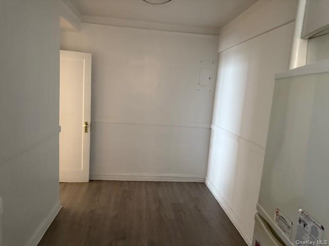 118-14 83rd Avenue, Unit 3G Queens, NY 11415 - Photo 9 of 12 Unfurnished room featuring dark wood-type flooring and electric panel