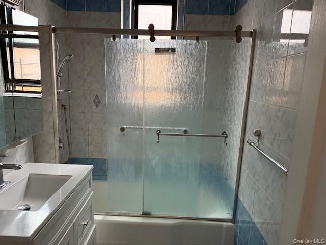 118-14 83rd Avenue, Unit 3G Queens, NY 11415 - Photo 10 of 12 Bathroom featuring shower / bath combination with glass door and vanity