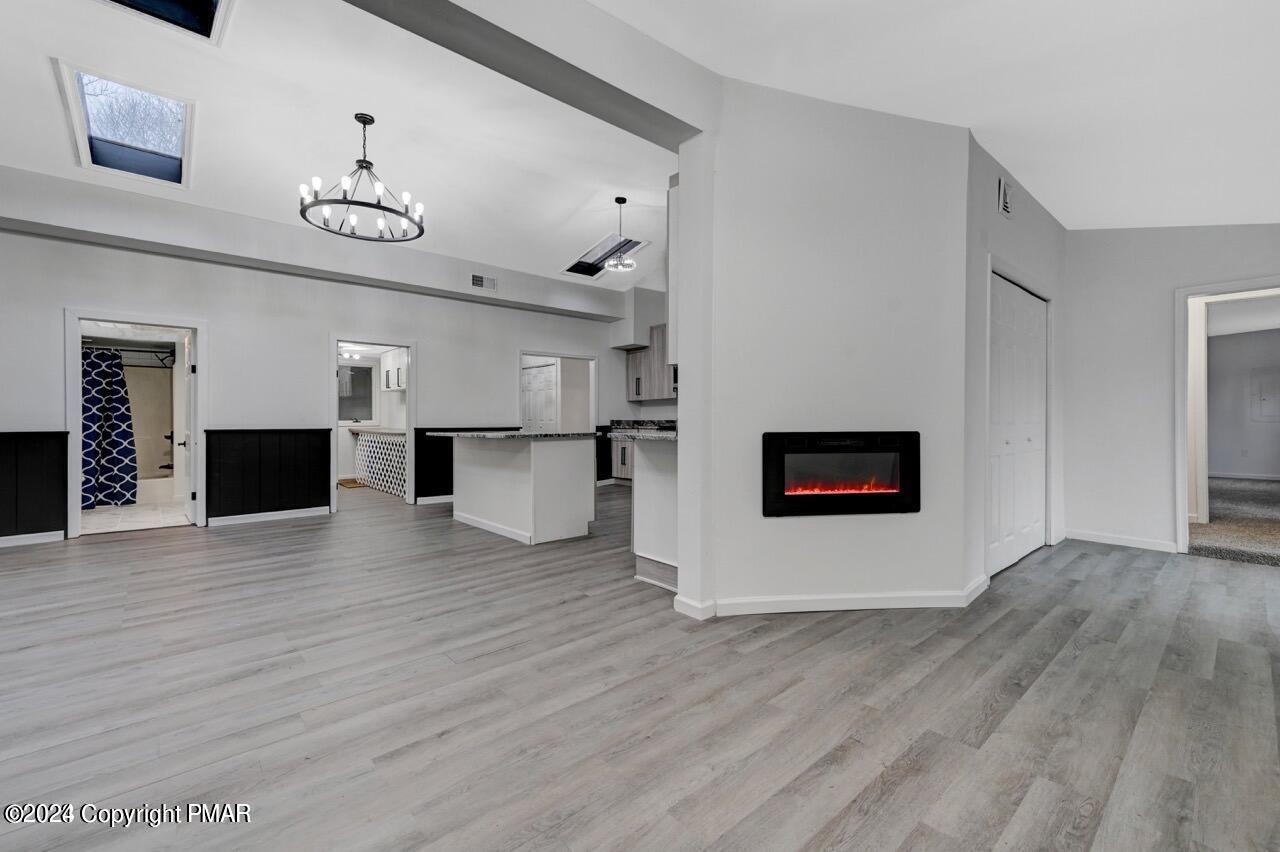 113 Java Hill East Stroudsburg, PA 18302 - Photo 14 of 36 a view of a hallway with wooden floor and a kitchen