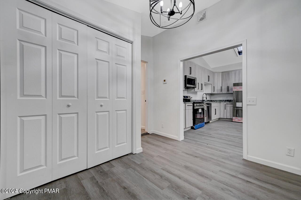 113 Java Hill East Stroudsburg, PA 18302 - Photo 28 of 36 an empty room with wooden floor cabinet and windows