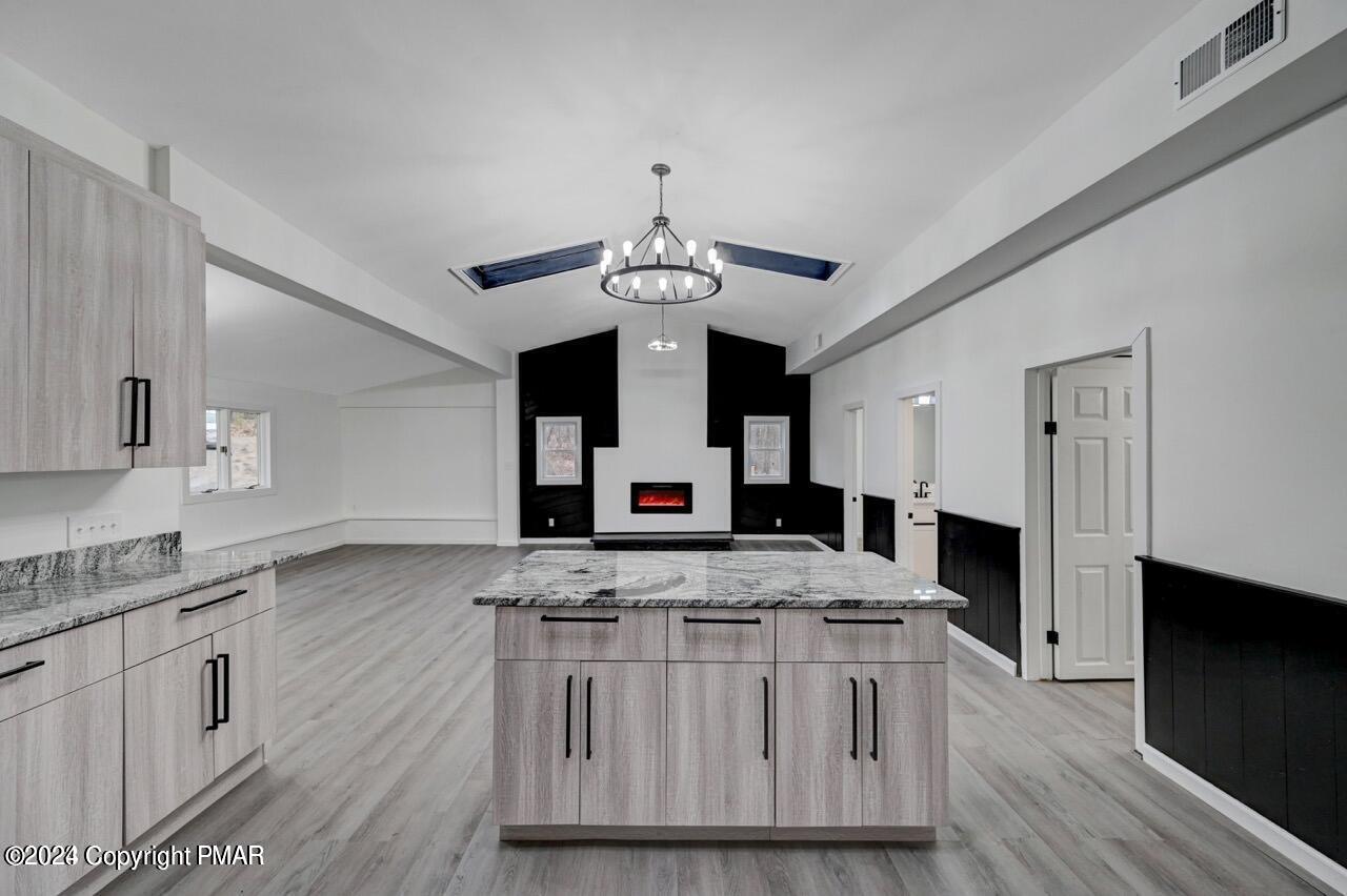 113 Java Hill East Stroudsburg, PA 18302 - Photo 3 of 36 a kitchen with stainless steel appliances granite countertop wooden floors and white cabinets