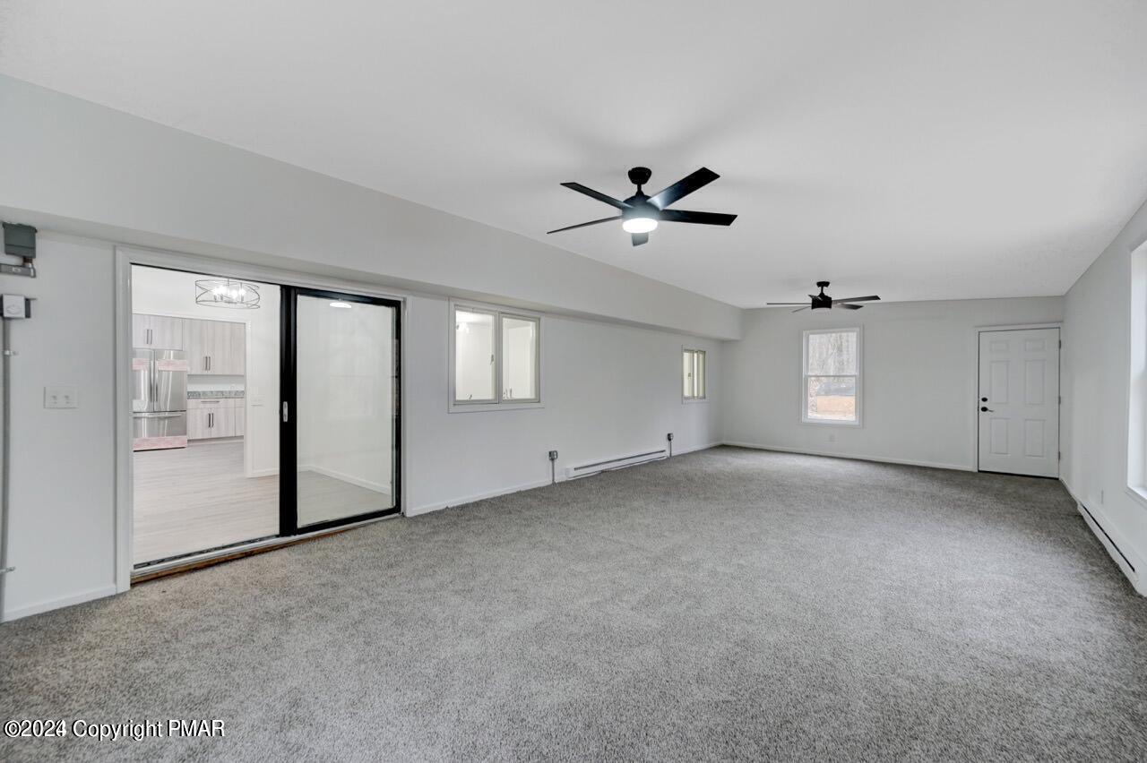 113 Java Hill East Stroudsburg, PA 18302 - Photo 32 of 36 an empty room with windows and ceiling fan