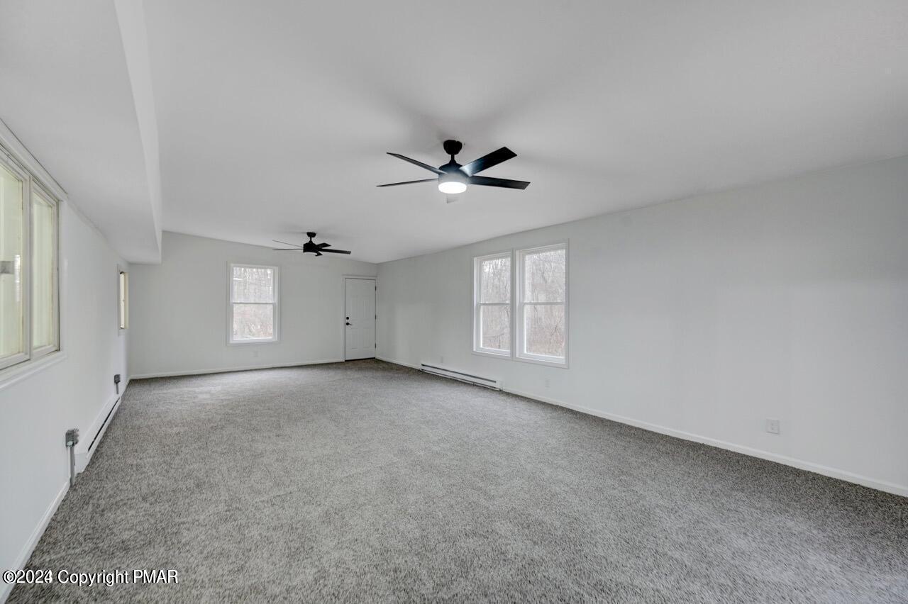 113 Java Hill East Stroudsburg, PA 18302 - Photo 33 of 36 an empty room with windows and ceiling fan