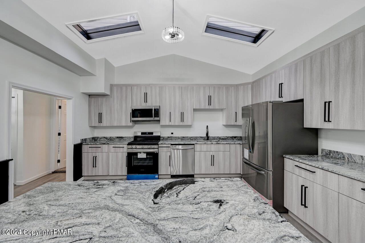 113 Java Hill East Stroudsburg, PA 18302 - Photo 5 of 36 a kitchen with granite countertop stainless steel appliances and wooden cabinets