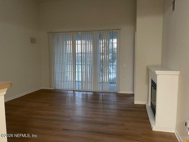 8550 Touchton Road, Unit 1436 Jacksonville, FL 32216 - Photo 13 of 37 a view of an empty room with wooden floor and a window