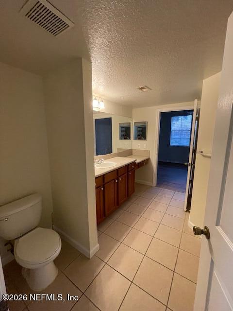 8550 Touchton Road, Unit 1436 Jacksonville, FL 32216 - Photo 16 of 37 a bathroom with a toilet sink and mirror