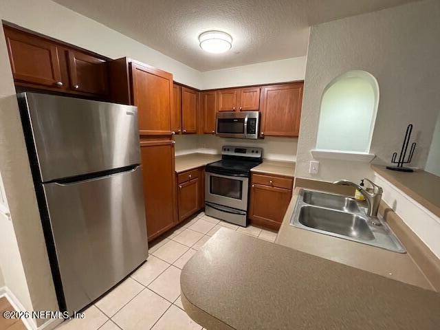 8550 Touchton Road, Unit 1436 Jacksonville, FL 32216 - Photo 10 of 37 a kitchen with stainless steel appliances a refrigerator stove and sink