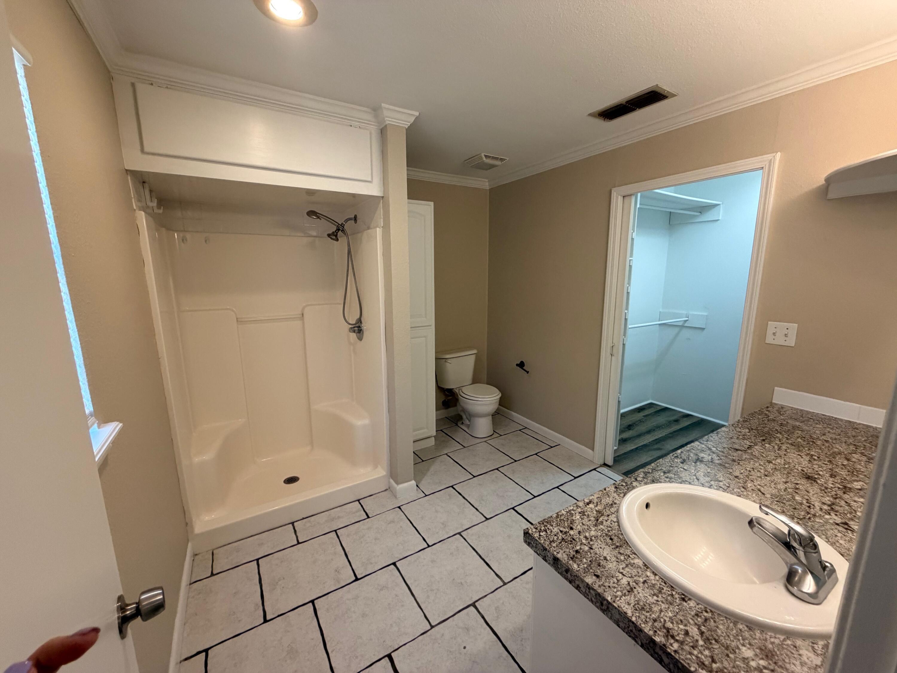 4310 42nd Street Lubbock, TX 79413 - Photo 18 of 25 a bathroom with a granite countertop sink and a mirror